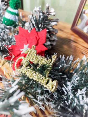 Bright decorations for the Christmas garland. New Year and Christmas. Christmas rose with your own hands and inscription Merry Christmasの写真素材