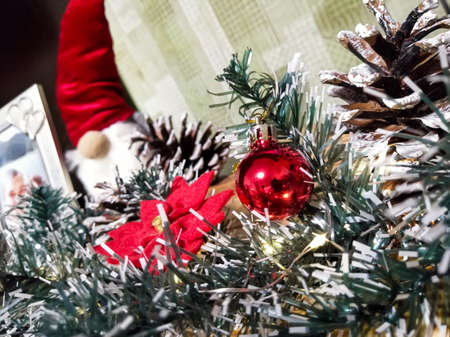 Bright decorations on the Christmas garland. Christmas and New Year. Christmas rose and Christmas ball.の写真素材