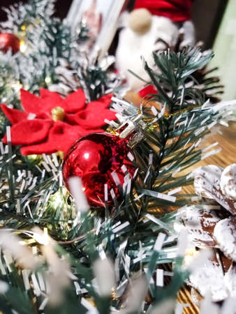 Bright decorations on the Christmas garland. Christmas and New Year. Christmas rose and Christmas ball.の写真素材