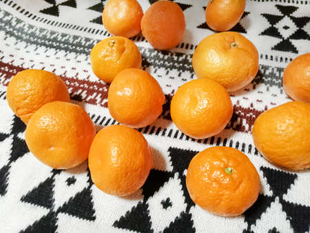 On the bedspread are bright oranges. Winter, festive motif.の写真素材