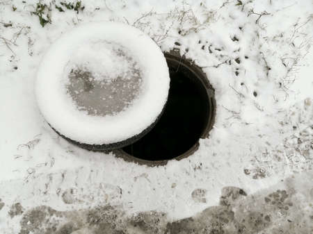 Open hatch on a winter road. Life-threatening.