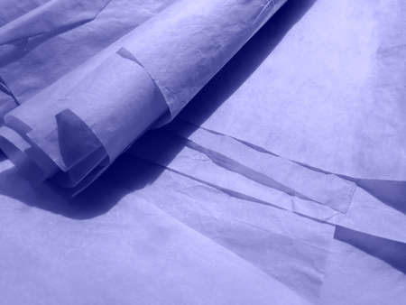 Old sheets of paper, like a crumpled scroll, lie in a chaotic order.の写真素材