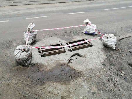 Fencing on the emergency section of the road. Crayons with sand and tape for emergency section windings.の写真素材