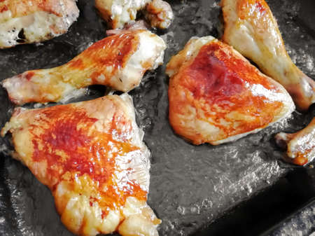 Beautiful chicken baked in the oven. Bright brown crust. chicken on a baking sheet.の写真素材