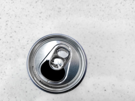 Tin can top view. Open tin can. Tin can on the table - top view. The top of the tin can is open for drinking.の写真素材