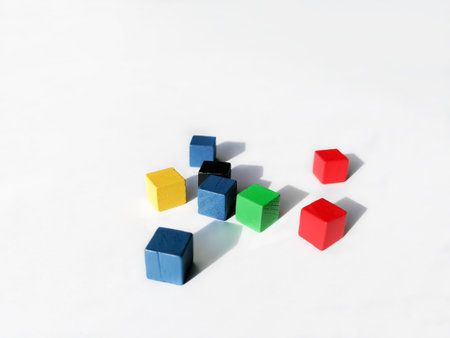 Colored, wooden cubes are scattered across a white background. Bright cubes on a white background. Children's cubes. wooden cubes for the game.の写真素材