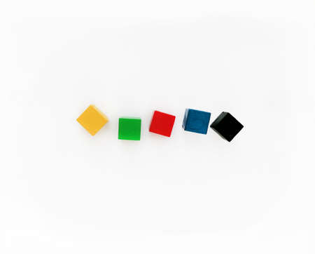 Five colored cubes lie in a row on a white background. Cubes for the inscription. Place under the...