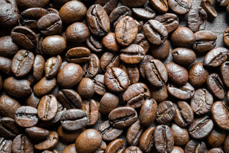 coffee beans. Lots of coffee beans close-up. Beautiful coffee beans on the table. The background is made of coffee beans.の写真素材