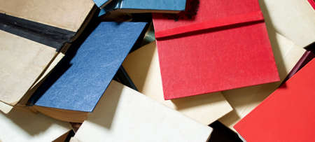 A lot of books are piled up. Color books are on top of each other. Open books are paliturai up. so many different books.の写真素材