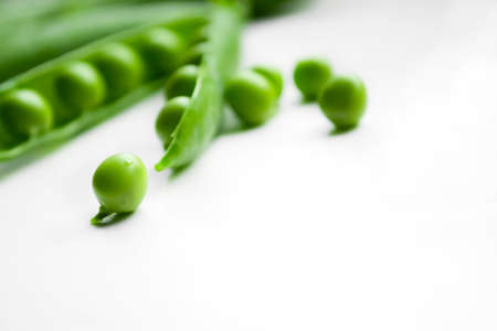 Green pea beans on a white background. On white green peas. Beautiful seeds of green peas.の写真素材