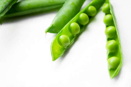 Green peas on a white background. rows of peas in a pod. Beans in a pod. Peas in a pod on a white...