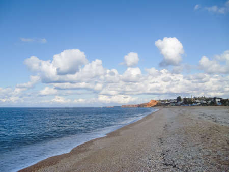 ocean shore. Beautiful sandy beach by the sea. Shiirk sandy beach next to the sea. Cloudy skies over the beach.の写真素材