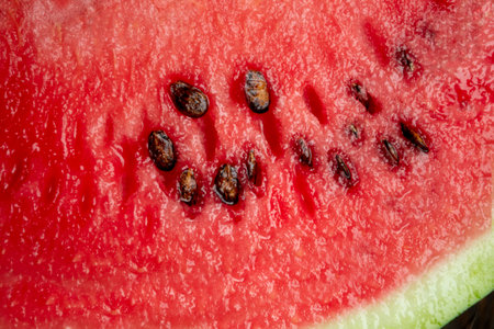 Watermelon pulp is a close shot. The red flesh of a watermelon with seeds is a close camera shot. Macrophoto of watermelon.の写真素材