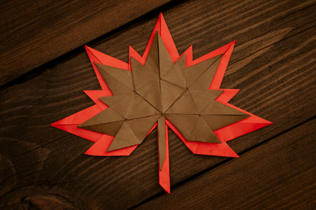 Maple leaves made of paper lie on top of each other. wooden table and maple leaves made of paper....