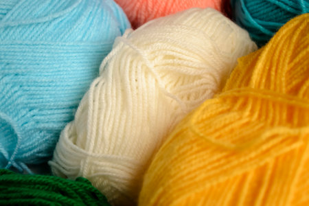 The background is made of threads of different flowers. colored yarn. Woolen threads of different...