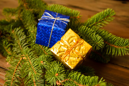 Two gifts on the Christmas tree. On the Christmas tree are yellow and blue gifts. Gifts in the colors of the flag of Ukraine. New Year's gifts on the Christmas tree. presents on a spruce branch.の写真素材