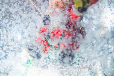 In the snow globe is Santa Claus. Snow falls in the globe. A snow toy. The focus is blurred because of the snow.の写真素材