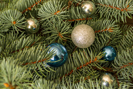 Gray and blue toys on the Christmas tree. Festive decorations on the branches of spruce. Glass toys on the Christmas tree.の写真素材