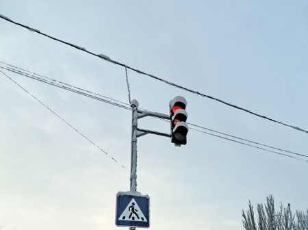 Road signs on a lamppost. Road signs and traffic lights on the pole are covered with snow. The pillar with signs in winter is covered with white snow. theの写真素材