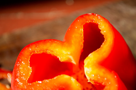 Bell pepper - chopped. Red bell pepper nearby. A close-up of a cut of red sweet pepper.の写真素材