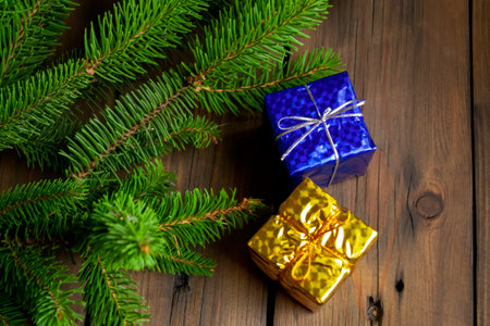 Two gifts on the Christmas tree. Christmas presents on a spruce branch. On the tree are yellow and blue gifts. Gifts in the colors of the flag of Ukraine. Yellow-blue gifts are the flag of Ukraine.の写真素材