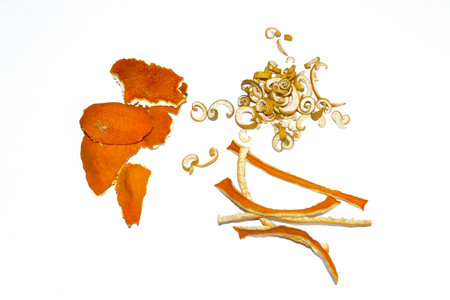 Skins from tangerine, orange and sweetie on a white background. Dried citrus skins for compote and tea. dried citrus skins on a white background. ingredients for citrus tea.の写真素材