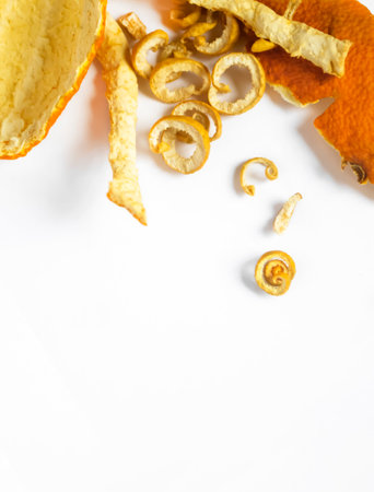 In one side of the photo together lie dry skins of mandarin, orange and sweetie. Ingredients for tea are dried citrus fruits. Dried citrus skins.の写真素材