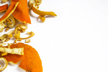 In one side of the photo together lie dry skins of mandarin, orange and sweetie. Dried citrus skins. Ingredients for tea are dried citrus fruits.の写真素材