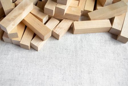 Wooden block on the fabric. On the linen fabric there are wooden block of the designer. a wooden construction set for children lies in a heap on the table.の写真素材