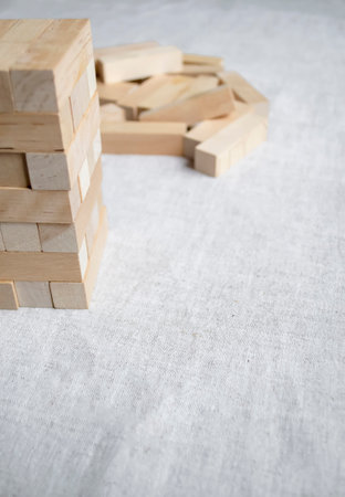 The game of the Tower is wooden on the table. wooden construction set for children. Board game Tower with wooden elements.の写真素材