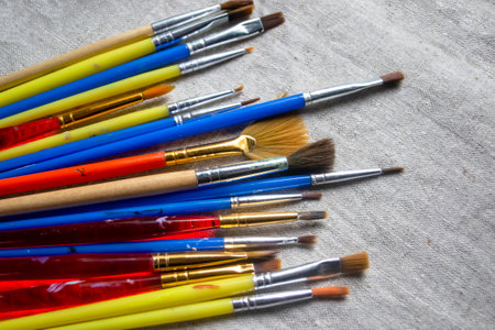 Lots of colored brushes for drawing. There are many artistic tassels on the fabric. Brushes for artists on linen fabric.の写真素材