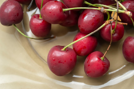 Cherries on a plate. Close-up of red cherries. A lot of fresh cherries - summer berries.の写真素材