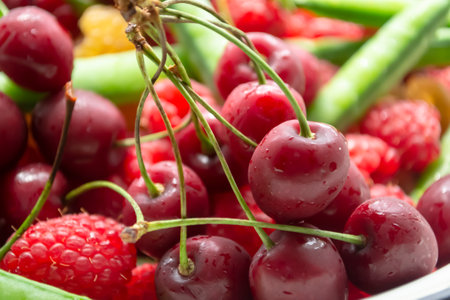 Summer berries together - cherries, green peas and raspberries. Cherries, raspberries and green...