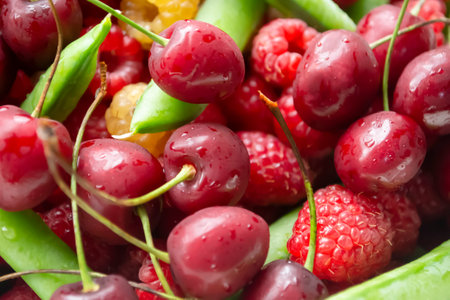 Cherries, raspberries and green peas. Background photo of berries. Summer berries together - cherries, green peas and raspberries.の写真素材