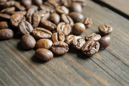 Coffee beans on a wooden table. many coffee beans. Fresh coffee on a wooden board.の写真素材
