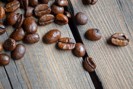 Coffee beans on a wooden table. many coffee beans. Fresh coffee on a wooden board.の写真素材