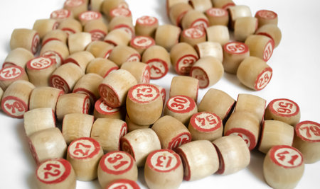 A lot of barrels from the bingo on a white background. Among the wooden barrels stands out with the number 13. Barrels are wooden with red numerals.の写真素材