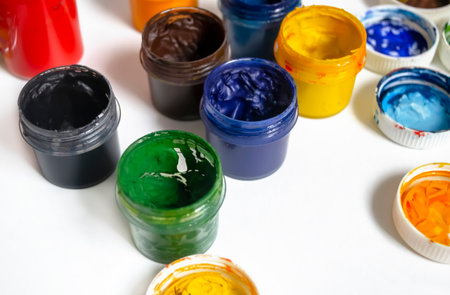Bonks with watercolor paint. Watercolor paints of different colors on a white background. Jars with watercolors. oil paints on a white background. Paints for artists.の写真素材