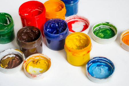 Bonks with watercolor paint. Paints for artists .Watercolor paints of different colors on a white background. Jars with watercolors. oil paints on a white background.の写真素材