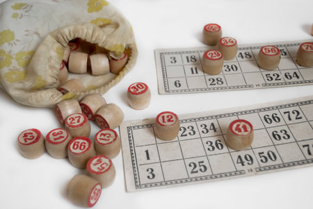 Elements of a lotto game. Board game on a white background - barrels and bingo cards.An old lotto game on a white background.の写真素材