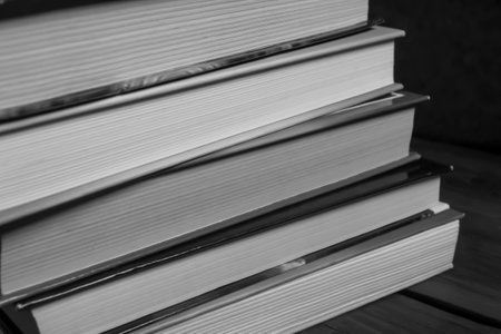 A stack of books. Photos in black and white - books stacked on top of each other - shooting up close.の写真素材