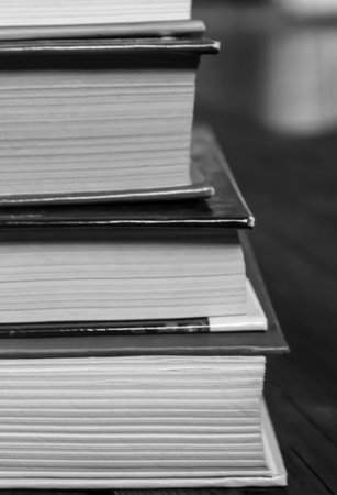 A stack of books. Photos in black and white - books stacked on top of each other. shooting up close.の写真素材