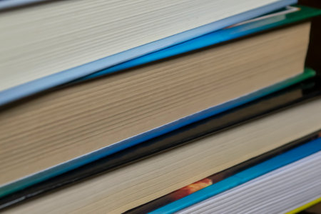 A stack of books on a dlervian table. A lot of books lie together. The books lie close to each other. Business and training - books for students.の写真素材