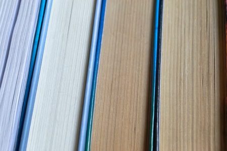 A stack of books on a dlervian table. A lot of books lie together. The books lie close to each other. Business and training - books for students.の写真素材