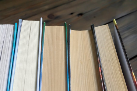 A stack of books on a dlervian table. A lot of books lie together. The books lie close to each other. Business and training - books for students.の写真素材