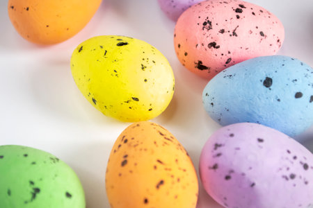 Decorated eggs for Easter lie on a white background. Decorations for Easter - symbolism - colored eggs. Quail eggs at the point are painted in different colors.の写真素材