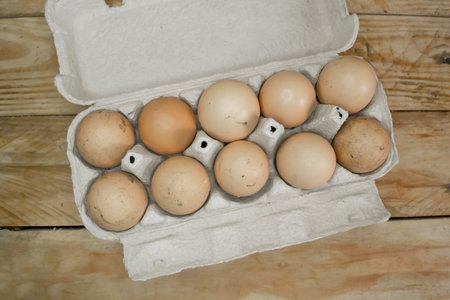 LOtok with eggs. An open tray with dirty eggs. Lots of dirty eggs. Eggs in the mud are not washed.の写真素材