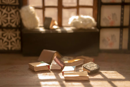 Books are scattered next to the sofa - a miniature with your own hands. A light falls from the window onto scattered books - a roombox.の写真素材