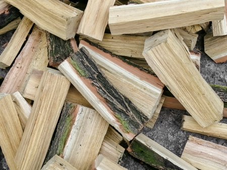 A mountain of firewood. Chopped firewood for the winter. acacia firewood. a lot of firewood - harvesting wood for heating the house.の写真素材