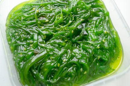 Background image of seaweed lettuce. Wakame seaweed chuka salad with sesame. Useful algae - wakame.の写真素材